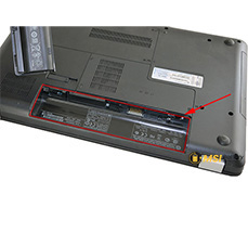 Printed on the label inside the battery compartment of the laptop